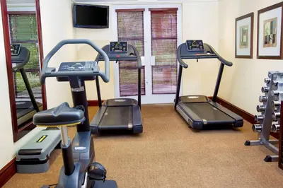 a gym with treadmills and elliptical machines at Southern Sun Mbombela in Nelspruit