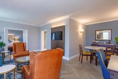 a waiting room with tables and chairs at Southern Sun Mbombela in Nelspruit