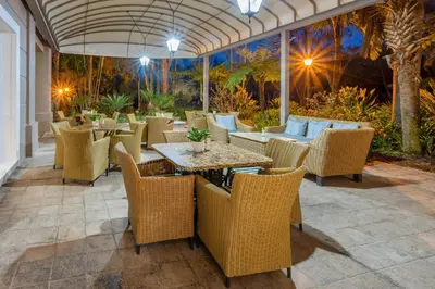 an outdoor dining area with tables and chairs at Southern Sun Mbombela in Nelspruit