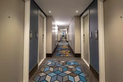 a hallway with a tile floor in a building at StayEasy Mbombela in Nelspruit