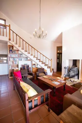 a living room with a couch and a table at Spitskop Plaashuis in Lydenburg