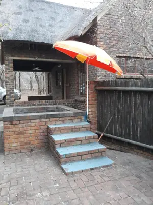 a umbrella sitting on top of a set of stairs at African Sky in Marloth Park