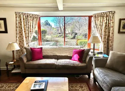 a living room with a couch and a large window at Galashiels in Dullstroom
