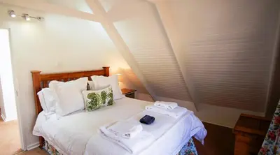 a bedroom with a bed with towels on it at Galashiels in Dullstroom