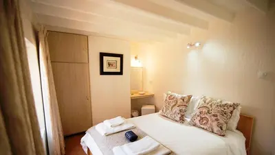 a bedroom with a bed with towels on it at Galashiels in Dullstroom