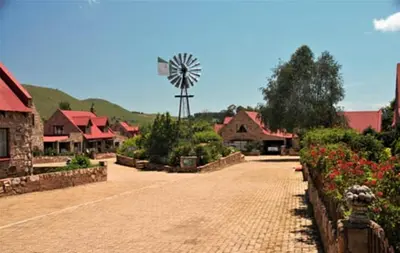 a cobblestone street with a windmill in a village at Galashiels in Dullstroom