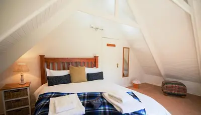 a bedroom with a bed with towels on it at Galashiels in Dullstroom