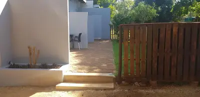 a wooden gate to a patio with a fence at Purdy's Place in Louis Trichardt