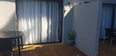 a room with a window with a table and a plant at Purdy's Place in Louis Trichardt