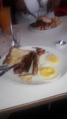 two plates of food on a table with eggs and bacon at Tehilah in Sabie