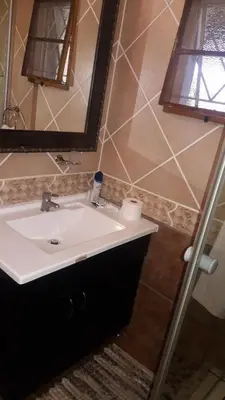 a bathroom with a sink and a mirror at Tehilah in Sabie