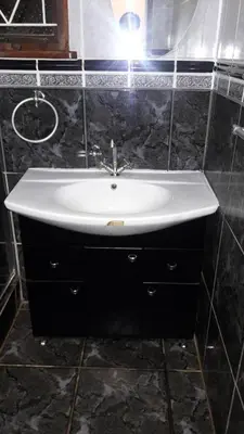 a bathroom sink with a light on top of it at Tehilah in Sabie