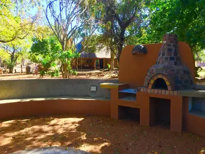 a playground with a bench and a pizza oven at Lamai Safari Lodge in Balule Game Reserve