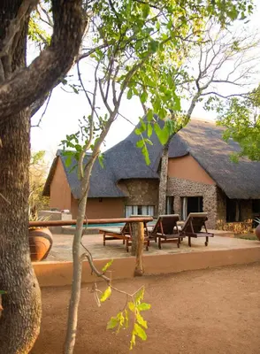 a building with picnic tables and benches in front of it at Lamai Safari Lodge in Balule Game Reserve