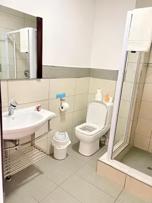 a bathroom with a toilet and a sink at Rio Vista Lodge in Malelane