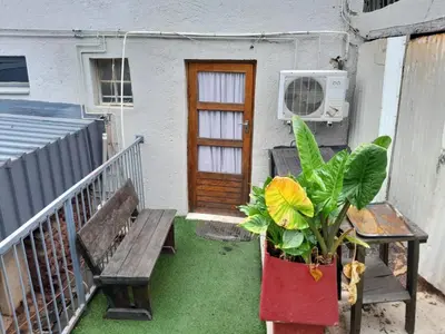 a porch with a bench and a door and a plant at Yacht View Lodge in Schoemansville