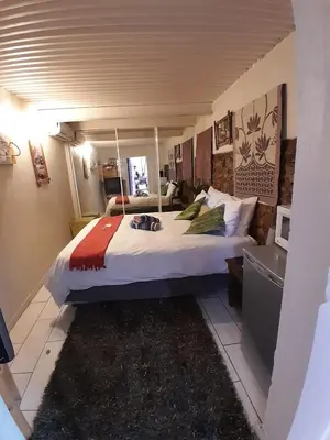 a bedroom with a large bed in a room at Yacht View Lodge in Schoemansville