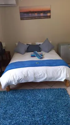 a bed with two books on it in a bedroom at Yacht View Lodge in Schoemansville