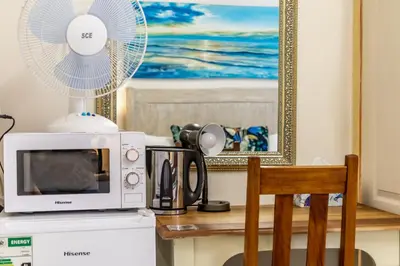 a microwave oven sitting on top of a kitchen counter at Berghaan Pretoria in Pretoria