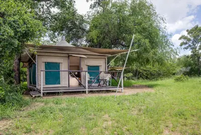 a small house in the middle of a field at Tangala Safari Camp in Thornybush Game Reserve