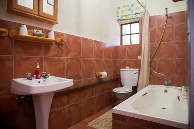 a bathroom with a sink and a toilet and a tub at Haus Kopatsch in Hazyview