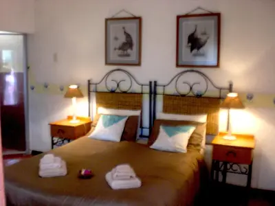 a bedroom with a bed with two towels on it at Haus Kopatsch in Hazyview