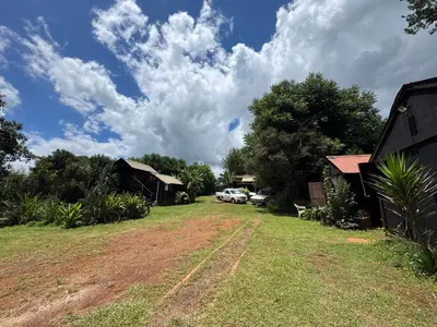 a view of a yard with a car parked in it at Sabie Gypsy's Backpackers in Sabie