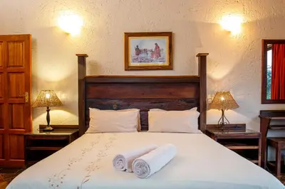 a bedroom with a bed with two towels on it at Sondela Nature Reserve & Spa Makhato Lodges in Bela-Bela