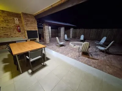 a room with a table and chairs on a patio at Sondela Nature Reserve & Spa Chalets in Bela-Bela