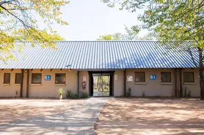 a building with a large door and a driveway at Phalaborwa Safari Park, A Forever Resort in Phalaborwa