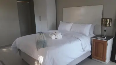 two stuffed animals sitting on top of a bed at Lullaby Guesthouse in Tzaneen
