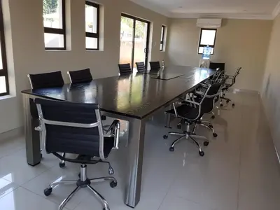a large conference room with a long table and chairs at Lullaby Guesthouse in Tzaneen