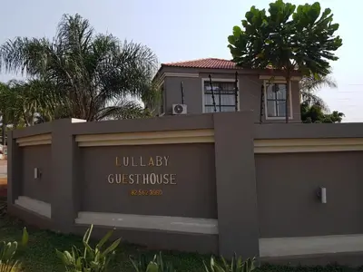 a sign for a villeway guest house in front of a house at Lullaby Guesthouse in Tzaneen