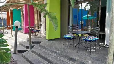 a group of chairs and tables in front of a building at Elephant Springs in Bela-Bela