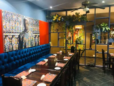 a dining room with tables and a painting on the wall at Elephant Springs in Bela-Bela