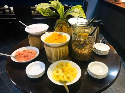 a table with bowls of fruit on a table at Elephant Springs in Bela-Bela