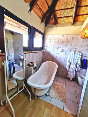 a bathroom with a tub and a sink at John and Noleen's place in Marloth Park