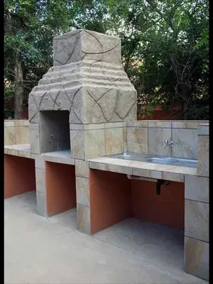 a stone counter with a sink in a stone oven at John and Noleen's place in Marloth Park