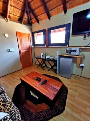a living room with a coffee table and a tv at John and Noleen's place in Marloth Park