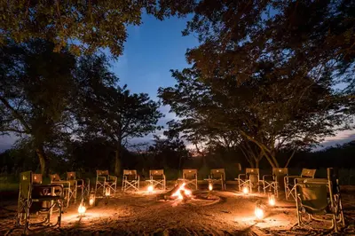 a group of chairs sitting around a circle with lights at Makuwa Safari Lodge in Mbabat