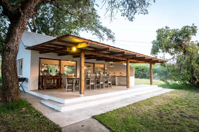 a pavilion with a table and chairs on a patio at Makuwa Safari Lodge in Mbabat