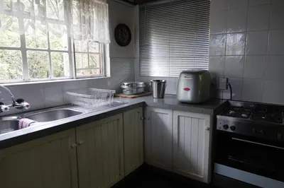 a kitchen with a sink and a stove at Marloth Park Hippo House in Marloth Park