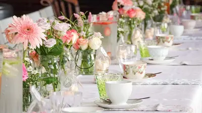 a table topped with vases filled with pink flowers at Spacube Luxury Suites and Spa in Pretoria