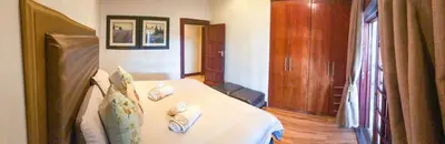 a bedroom with a bed with towels on it at Spacube Luxury Suites and Spa in Pretoria