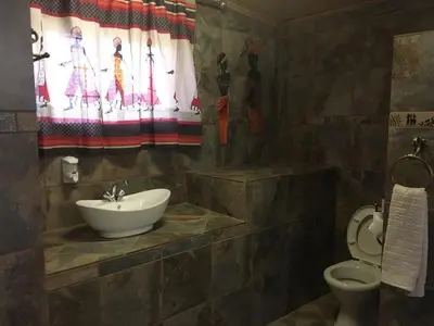 a bathroom with a sink and a toilet at Esmarline Lodge in Brits