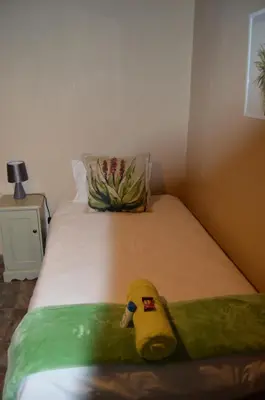 a stuffed animal is sitting on a bed at Esmarline Lodge in Brits