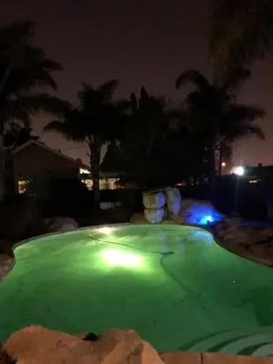 a green golf course at night with palm trees at Africaren Budget Stay in Kempton Park