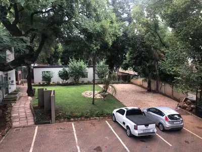 two cars parked in a parking lot in a yard at 31 at Murray in Pretoria