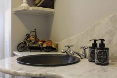 a bathroom sink with a motorcycle sitting on a counter at 31 at Murray in Pretoria