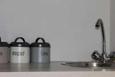 three coffee cans sitting on a counter next to a sink at 31 at Murray in Pretoria